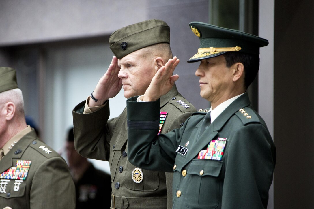 Commandant of the Marine Corps, Gen. Robert B. Neller, center, salutes next to Gen. Kiyohumi Iwata, right, the Japan Ground Self-Defense Force chief of staff, at Tokyo, Japan, Nov. 25, 2015. Neller met with Iwata and other Japanese defense officials during his Japan visit. (U.S. Marine Corps photo by Staff Sgt. Gabriela Garcia/Released)