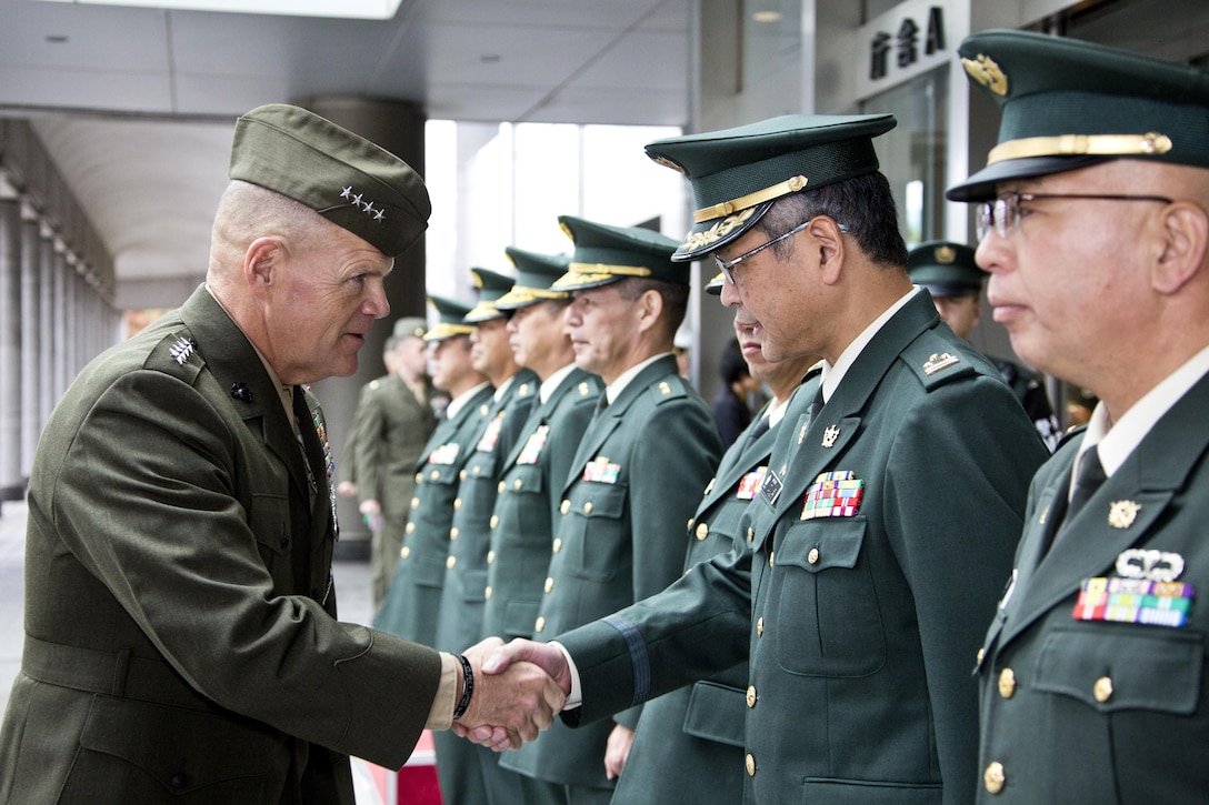 Commandant of the Marine Corps, Gen. Robert B. Neller, center, greets Japanese service members at Tokyo, Japan, Nov. 25, 2015. Neller met with Japanese defense officials during his Japan visit. (U.S. Marine Corps photo by Staff Sgt. Gabriela Garcia/Released)