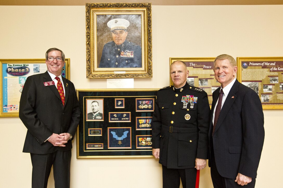 Commandant of the Marine Corps, Gen. Robert B. Neller poses with guests after a portrait unveiling ceremony at Atlanta, Ga., Dec. 2, 2015. Neller was the guest of honor speaker at retired Gen. Raymond G. Davis's portrait unveiling ceremony inside the Floyd Veterans Memorial Building. (U.S. Marine Corps photo by Staff Sgt. Gabriela Garcia/Released)