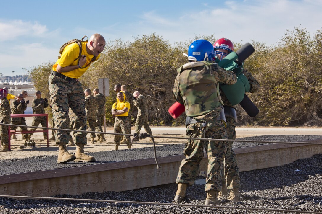 A U.S. Marine yells at recruits executing pugil sticks at Marine Corps Recruit Depot San Diego, Calif., Dec. 3, 2015. Pugil Sticks is part of the 12 week training every recruit must undergo before earning the title of a U.S. Marine. (U.S. Marine Corps photo by Staff Sgt. Gabriela Garcia/Released)
