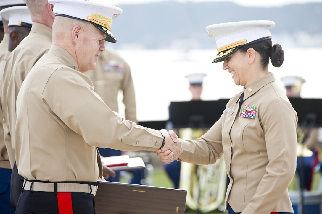 Commandant of the Marine Corps, Gen. Robert B. Neller, congratulates a Marine during a ceremony at Point Loma, Calif., Dec. 3, 2015. Neller was the guest of honor at the superior achiever ceremony for Marines of the Western and Eastern Recruiting Region. (U.S. Marine Corps photo by Staff Sgt. Gabriela Garcia/Released)