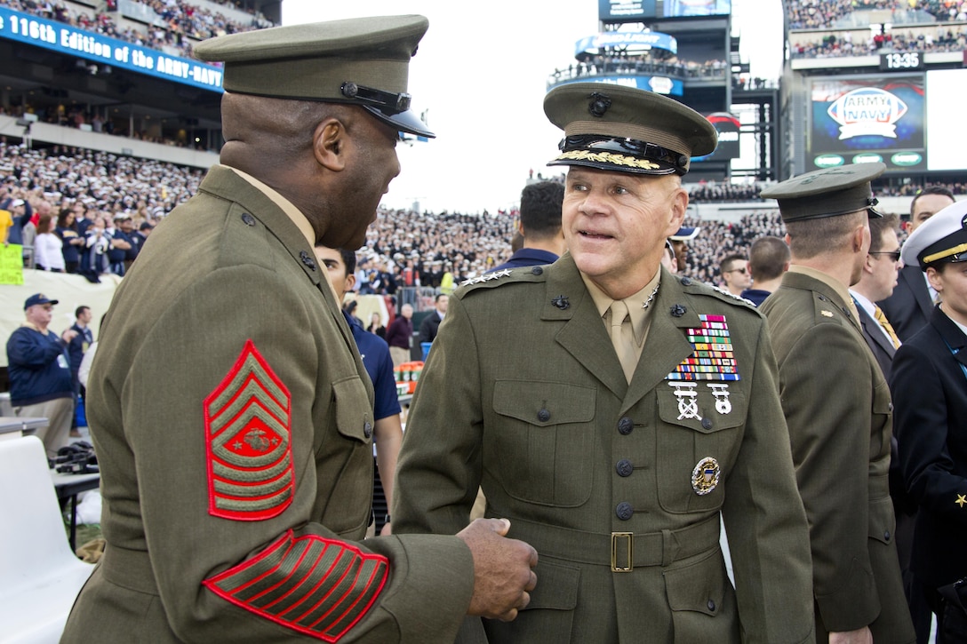Commandant of the Marine Corps, Gen. Robert B. Neller, right, talks with Sgt. Maj. of the Marine Corps Ronald L. Green during the Army-Navy game at Lincoln Financial Field in Philadelphia, Pa., Dec. 12, 2015. Neller participated in the game's coin toss done by Secretary of Defense, Ashton B. Carter. (U.S. Marine Corps photo by Staff Sgt. Gabriela Garcia/Released)