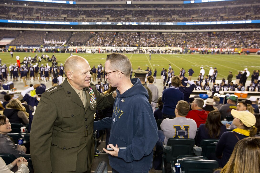 Commandant of the Marine Corps, Gen. Robert B. Neller talks to a fan of the Army-Navy game at Lincoln Financial Field in Philadelphia, Pa., Dec. 12, 2015. Neller participated in the game's coin toss done by Secretary of Defense, Ashton B. Carter. (U.S. Marine Corps photo by Staff Sgt. Gabriela Garcia/Released)