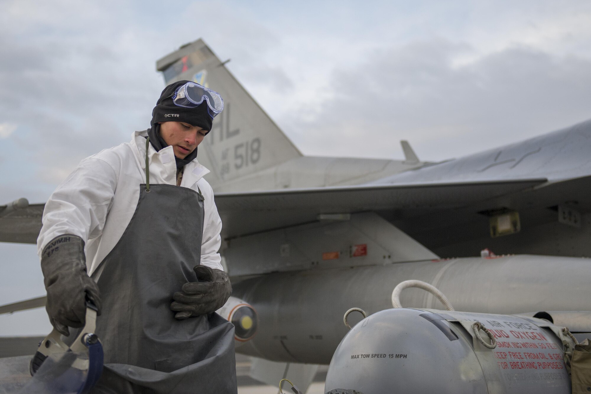 Airman 1st Class Frank Lopez, 455th Expeditionary Aircraft Maintenance Squadron dedicated crew chief, collects his equipment after filling the liquid oxygen tank on an F-16 Fighting Falcon at Bagram Airfield, Afghanistan, Jan. 06, 2016. The 455th EAMXS provides combat-ready aircraft to the air component commander in support of coalition forces throughout Afghanistan.  (U.S. Air Force photo/Tech. Sgt. Robert Cloys)
