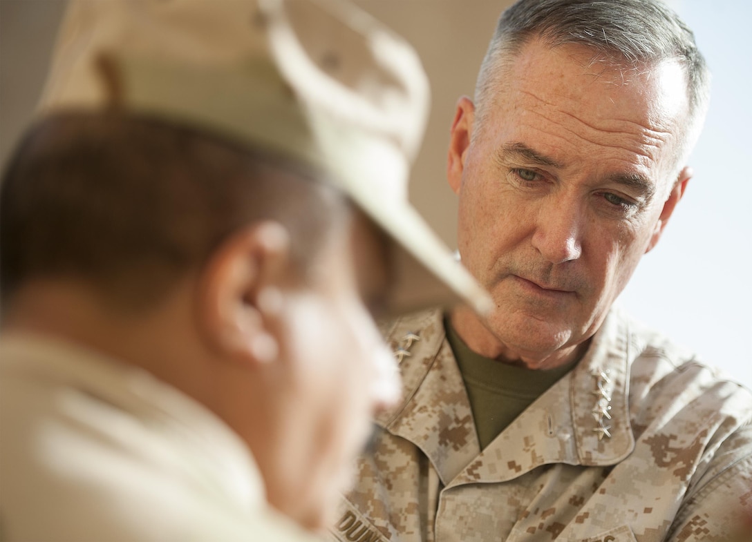 U.S. Marine Gen. Joseph F. Dunford Jr., chairman of the Joint Chiefs of Staff, listens to an Iraqi Army commander on Al Asad Air Base, Iraq, Jan. 7, 2016. Dunford met with U.S. and coalition leaders to assess progress in the Counter-ISIL efforts. DoD photo by Navy Petty Officer 2nd Class Dominique A. Pineiro