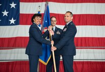 Maj. Gen. Stayce D. Harris, 22nd Air Force commander, passes the 934th Airlift Wing guidon to Col. Anthony G. Polashek, 934th Airlift Wing commander, during the Assumption of Command ceremony at the Minneapolis-St. Paul Air Reserve Station on Jan. 9. (U.S. Air Force photo by Master Sgt. Eric Amidon)