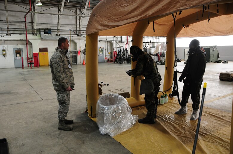 Pennsylvania Air National Guardsman from the 171st Air Refueling Wing practice decontamination training while process are observed by inspectors from Air Mobility Command during the unit’s efficiency inspection Oct. 18, 2015 (U.S. Air National Guard Photo by Senior Airman Allyson Manners/Released)