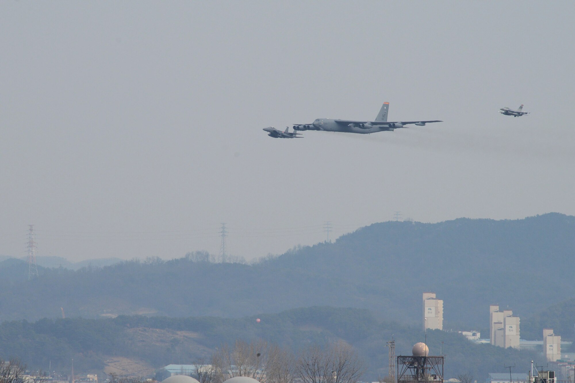 A U.S. Air Force B-52H  Stratofortress from Andersen Air Force Base, Guam, conducted a low-level flight in the vicinity of Osan Air Base, South Korea, in response to recent provocative action by North Korea Jan. 10, 2016. The B-52 was joined by a ROKAF F-15 Slam Eagle and a U.S. Air Force F-16 Fighting Falcon.  The B-52 is a is a long-range, heavy bomber that can fly up to 50,000 feet and has the capability to carry 70,000 pounds of nuclear or precision guided conventional ordnance with worldwide precision navigation capability. (U.S. Air Force photo/Airman 1st Class Dillian Bamman)