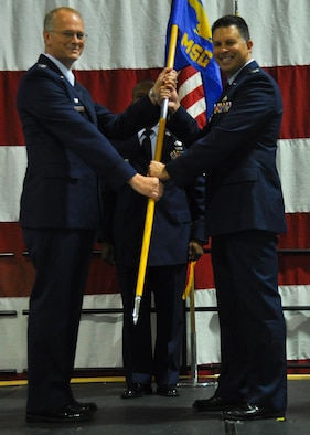 Col. Marty Hughes, 94th Mission Support Group incoming commander, receives the 94th MSG guidon from Col. Steven Parker, 94th Airlift Wing commander, at Dobbins Air Reserve Base, Ga. Jan 9, 2016. Hughes took command of the 94th MSG, symbolized by the passing of the guidon from the wing commander to himself.  (U.S. Air Force photo/ Senior Airman Miles Wilson)