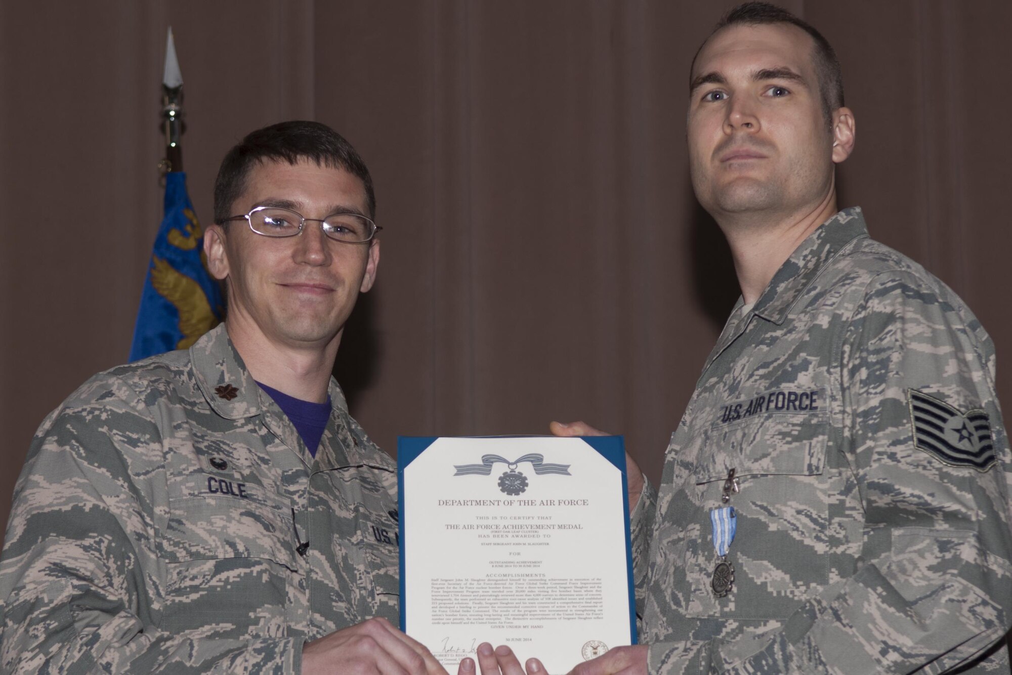 U.S Air Force Maj. George P. Cole III, 307th Maintenance Squadron commander, awards the Air Force Achievement Medal to Tech. Sgt. John M. Slaughter on Jan. 09, 2015, Barksdale Air Force Base, La.  Slaughter executed the first-ever Air Force Global Strike Command Force Improvement Program for the Air Force nuclear bomber forces.  The results of the program ensured improvement of the United States Air Force’s nuclear enterprise.  (U.S. Air Force photo by Senior Airman Callie Ware/Released)