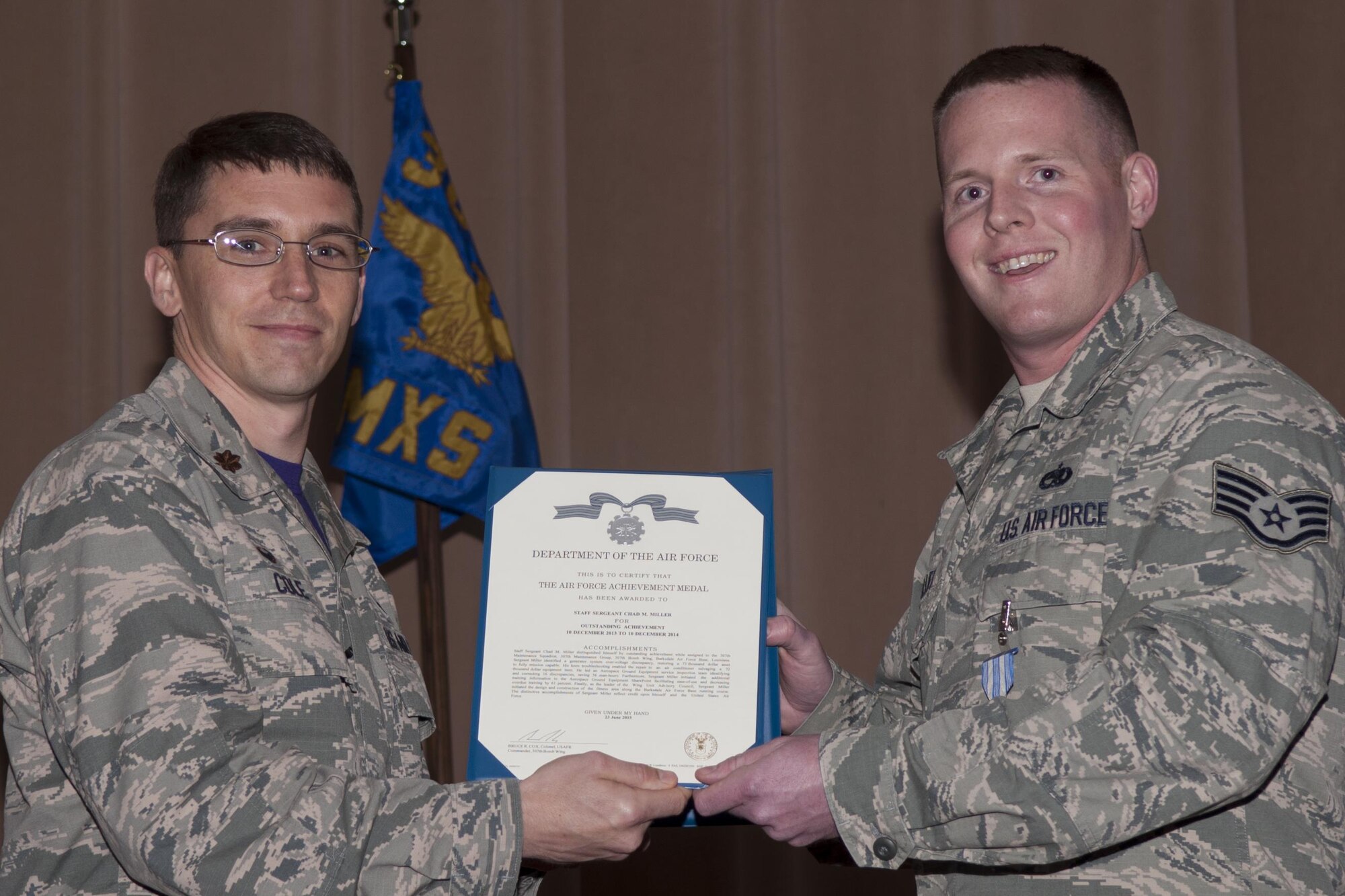 U.S Air Force Maj. George P. Cole III, 307th Maintenance Squadron commander, awards the Air Force Achievement Medal to Staff Sgt. Chad M. Miller on Jan. 09, 2015, Barksdale Air Force Base, La.  Miller received the award for outstanding accomplishments while in the Aerospace Ground Equipment Flight that resulted in reduction of man-hours, and initiation of various base improvement efforts.  (U.S. Air Force photo by Senior Airman Callie Ware/Released)