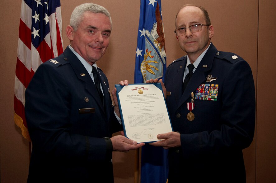 Chief of the 940th Wing Safety Office, Lt. Col. Lewis Harding is being presented the Meritorious Service Medal by the wing commander Col. John Trnka during his retirement ceremony at Beale Air Force Base, Calif. Harding is a fourth-generation military member who also served as a KC-135 co-pilot for the 134th Air Refueling Group. In total he has 33 years of military service.  (U.S. Air Force photo by Tech Sgt Kenneth McCann)