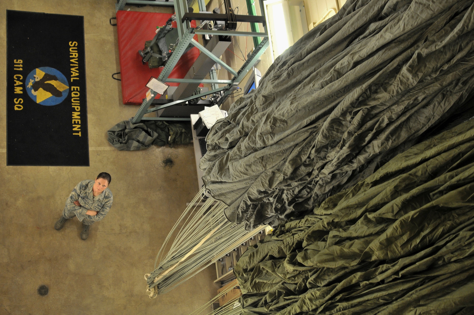 Staff Sgt. Kimberly Robinson, an aircrew flight equipment technician assigned to 911 Operations Support Squadron, stands near the parachute reality simulator at the Pittsburgh International Airport Air Reserve Station, Jan. 9, 2016. Robinson is an air reserve technician whose job is to inspect and maintain aircrew equipment. (U.S. Air Force photo by Airman Bethany Feenstra)