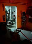 Airmen from the 459th Security Forces Squadron learn how to respond in an active shooter scenario during Expeditionary Active Shooter Training Nov. 7, 2015 at Joint Base Andrews, MD. The class is a new Air Force requirement for all deploying Airmen, as part of a new initiative to prepare Airmen for potential threats in deployed environments.  