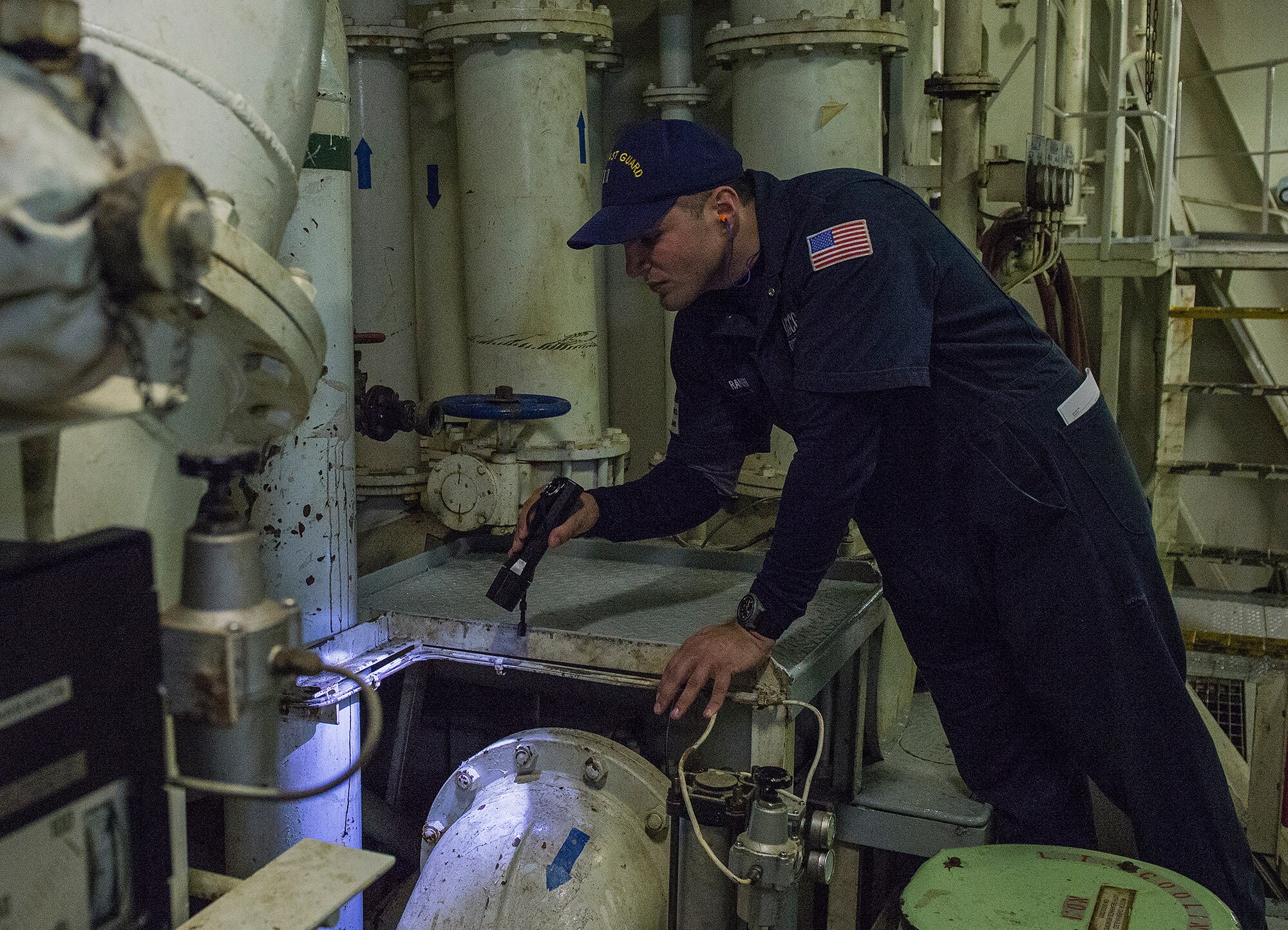 Lt. Peter Raneri, Coast Guard Activities Far East assistant chief of inspection, performs an inspection for certification aboard the U.S. flagship Green Ridge at Yokohama,, Japan, Dec. 16, 2015. The ship was inspected to ensure compliance with U.S. regulation and international safety and environmental standards. (U.S. Air Force photo by Senior Airman David C. Danford/Released)