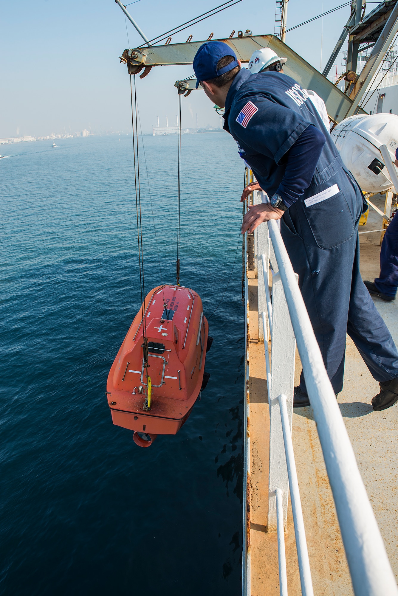 Lt. Peter Raneri, Coast Guard Activities Far East assistant chief of inspection, tests emergency lifesaving equipment during an inspection aboard the U.S. flagship Green Ridge at Yokohama, Japan, Dec. 16, 2015.  Equipment was inspected to ensure that they met safety standards set by U.S. regulation and international conventions.(U.S. Air Force photo by Senior Airman David C. Danford/Released)