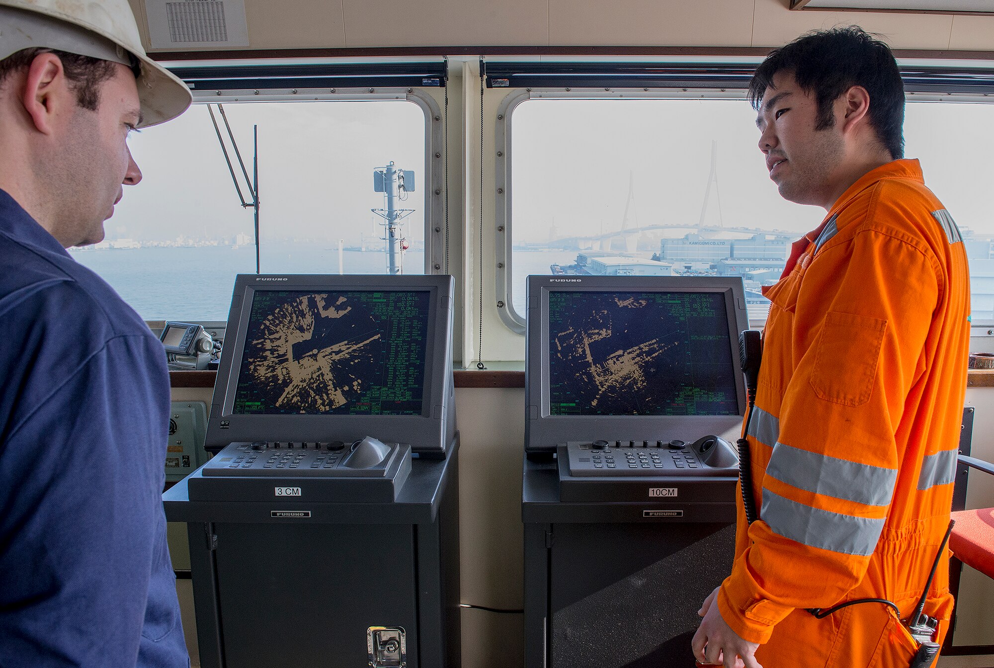 Lt. Matthew Arnold, Coast Guard Activities Far East Chief of Investigations, interviews Sun Yang, navigator and second mate for the U.S. flagged ship GREEN RIDGE, during an inspection at Yokohama, Japan, Dec. 16, 2015. Members of the crew were asked questions relating to their primary duties to ensure that they possessed the knowledge, training and equipment needed to perform their duties. (U.S. Air Force photo by Senior Airman David C. Danford/Released)