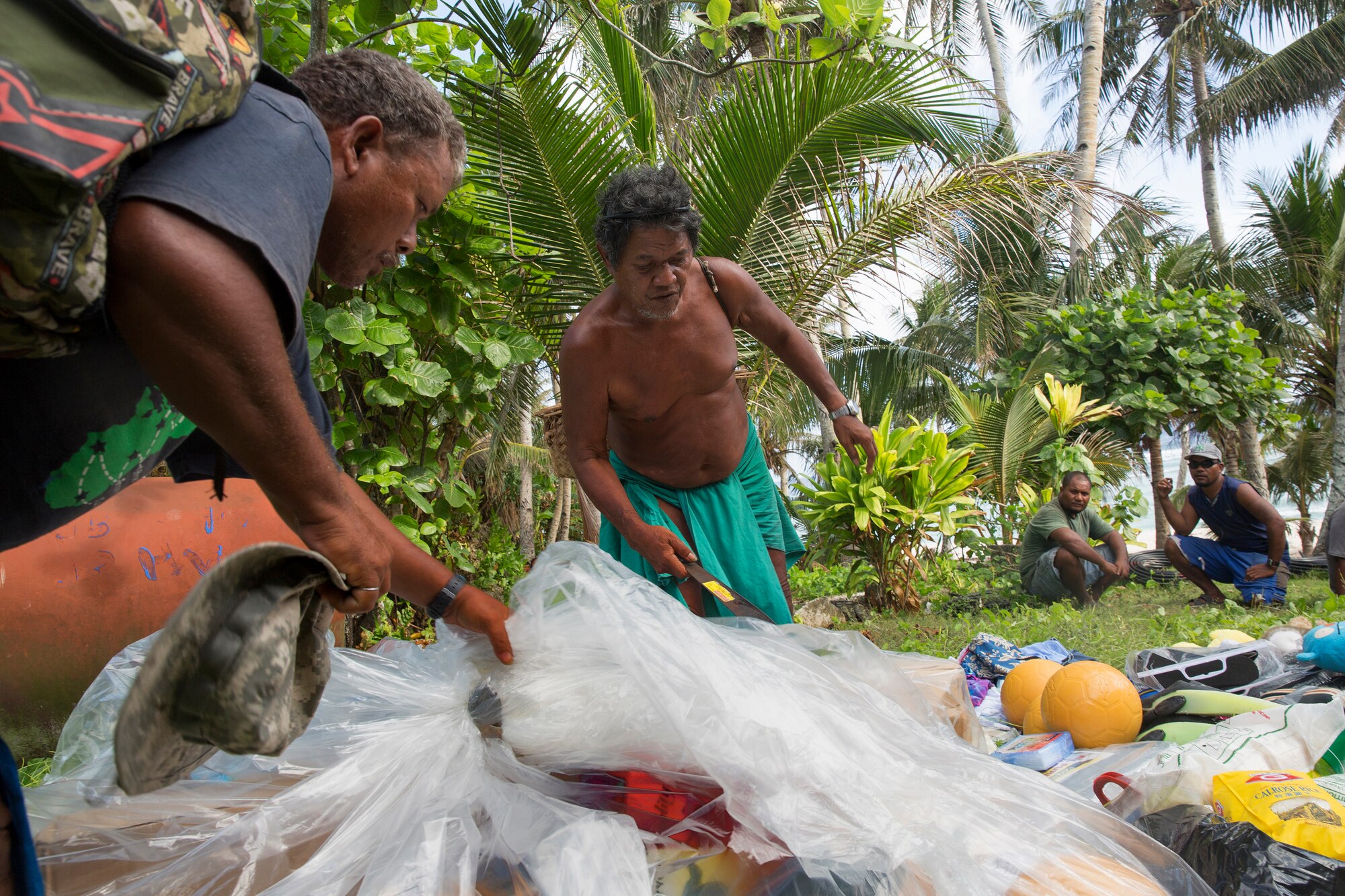 Louis Mangtau, Chief of Fais Island, sorts through supplies that were dropped during Operation Christmas Drop 2015, Dec. 8, 2015, at Fais Island, Federated States of Micronesia. Operation Christmas Drop is a humanitarian/disaster relief training event where C-130 crews provide critical supplies to 56 islands throughout the Commonwealth of the Northern Marianas, Federated States of Micronesia and Republic of Palau. This year marks the first ever trilateral execution that includes air support from the U.S. Air Force, Japan Air Self-Defense Force and the Royal Australian Air Force. (U.S. Air Force photo by Osakabe Yasuo/Released) 
 
