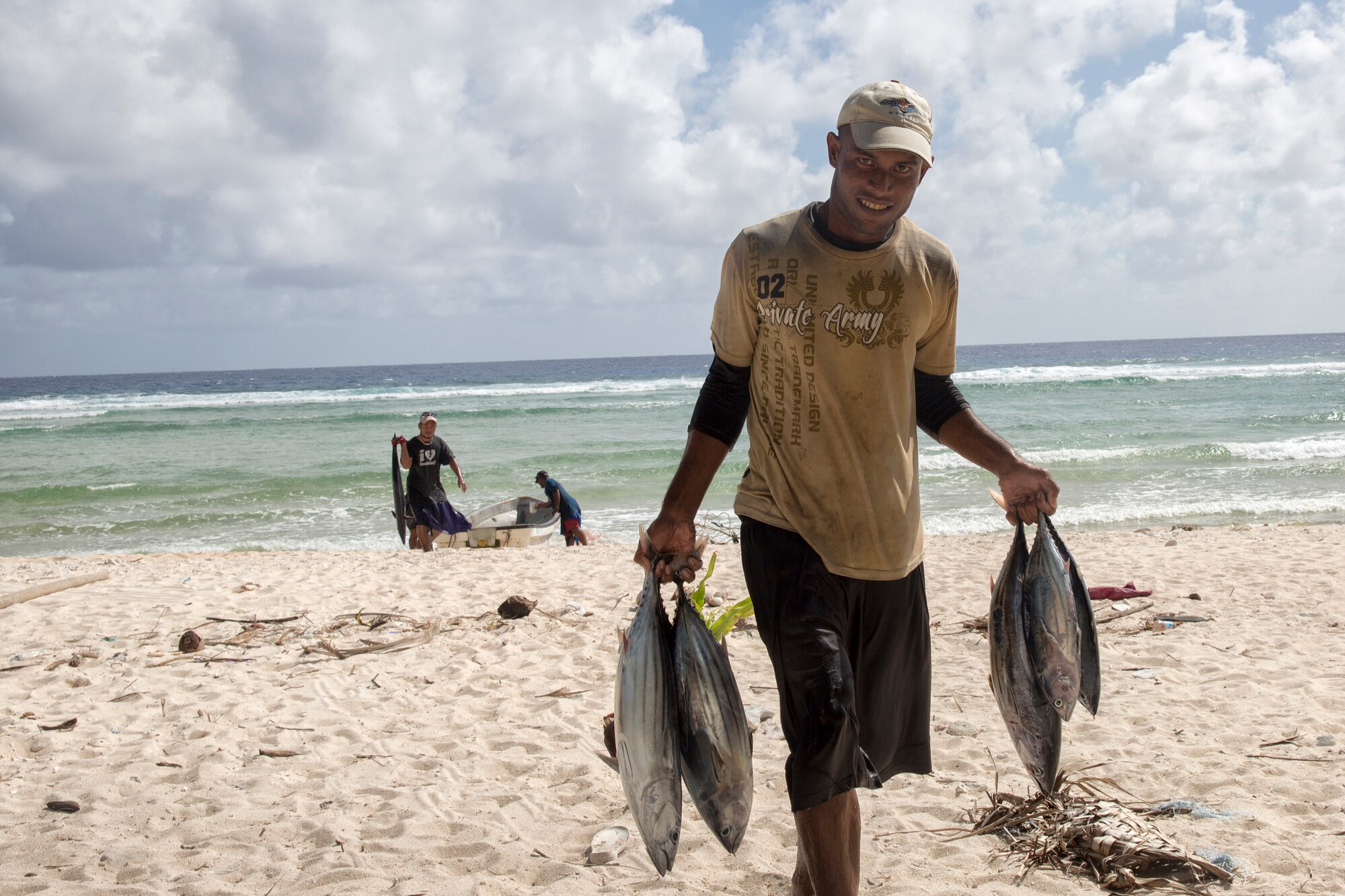 A fisherman carries tunas to a man's house at Fais Island, Federated States of Micronesia, Dec. 8, 2015. In Fais, there are three villages and one head chief who is Louis Mangtau, he divides harvests evenly. No one can touch it until he’s finished. After that each village then takes its harvests to distribute among the families evenly. (U.S. Air Force photo by Osakabe Yasuo/Released) 