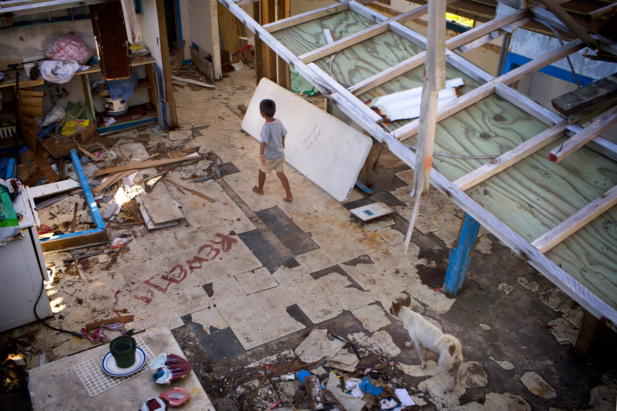 A child walks at a damaged school building at Falalop Island, Ulithi Atoll, Federated States of Micronesia, Dec. 7, 2015. Most of educational facility was devastated by Typhoon Maysak in March 2015. (U.S. Air Force photo by Osakabe Yasuo/Released) 