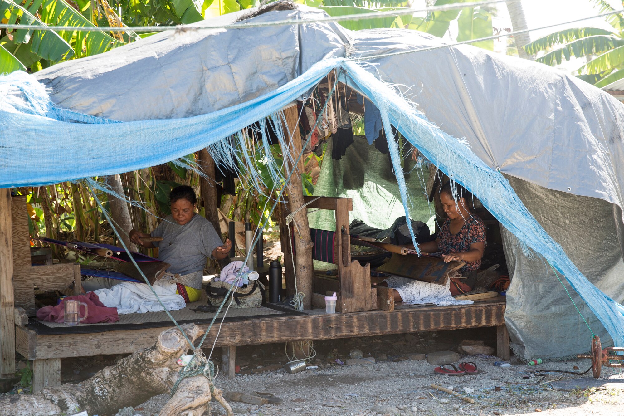 Ladies work at a house covered a plastic tarp at Falalop Island, Ulithi Atoll, Federated States of Micronesia, Dec. 7, 2015. Typhoon Maysak passed directly through the Ulithi Atoll in the FSM on the last day of March, tearing houses from their platforms and damaging almost all of the infrastructure. (U.S. Air Force photo by Osakabe Yasuo/Released) 