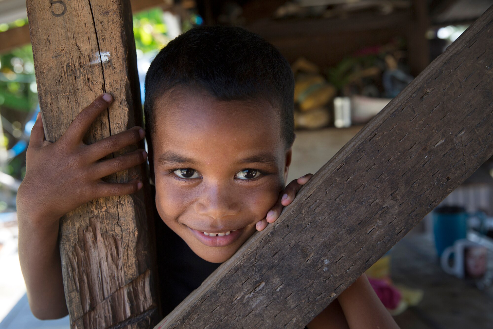 A boy shows a smile at an compound at Falalop Island, Ulithi Atoll, Federated States of Micronesia, Dec. 7, 2015. Falalop Island is one of the most damaged by Typhoon Maysak that hit here in March 2015. The outer southern eye wall of the Maysak passed directly over the Ulithi Atoll which is a group of outer islands near Yap. (U.S. Air Force photo by Osakabe Yasuo/Released) 