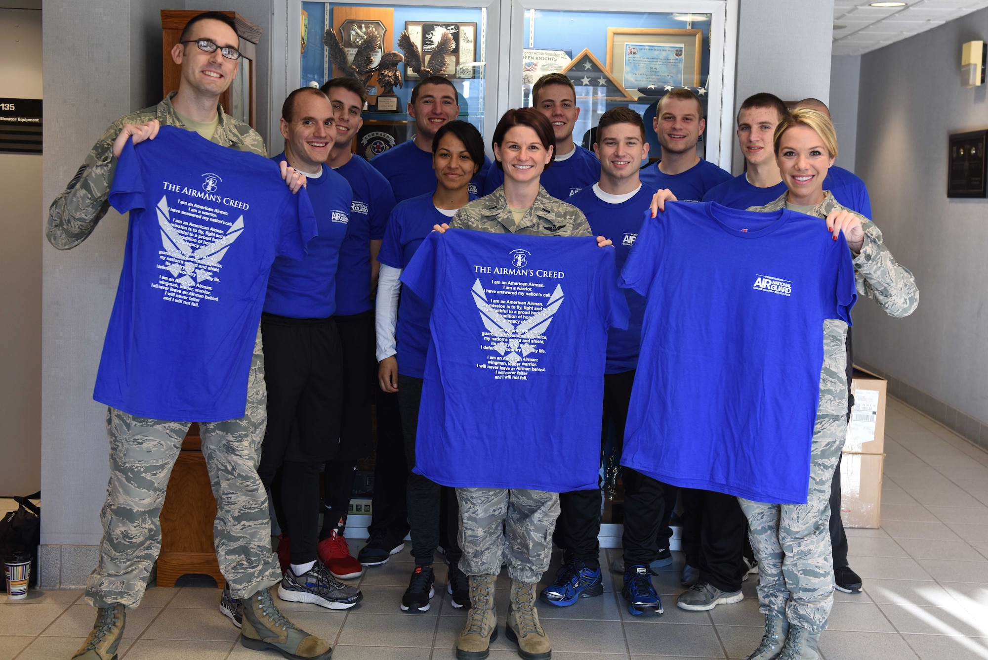 Members of the 193rd Special Operations Wing recruiting and retention team and Right Start program display new t-shirts that the 193rd SOW Association recently donated. The SOW Association sponsored the production of t-shirts to benefit the trainees of the Right Start program. More than 45 t-shirts were donated, which will serve as the uniforms for the participating trainees. Right Start is a program run by recruiting and retention and designed to bolster newly enlisted Airmen prior to military basic training. (U.S. Air National Guard photo by Staff Sgt. Claire Behney/Released)