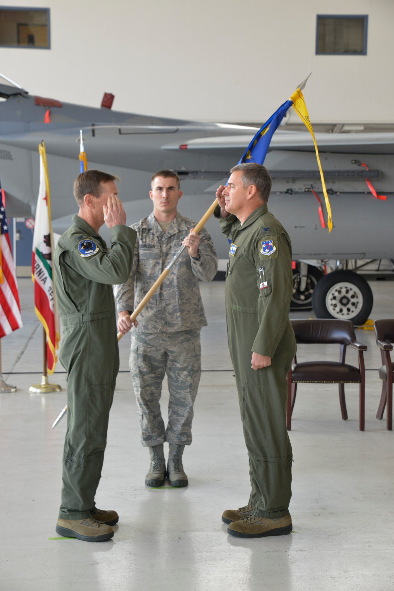 U.S. Air Force Col. John P. York, the outgoing 144th Operations Group commander, relinquishes command to U.S. Air Force Col. Steven J. Early. During the ceremony the recent accomplishments of the 144th Fighter Wing were discussed, the guidon was passed from the outgoing commander to the new commander and Col. Early's name was displayed on an F-15C Eagle. (Air National Guard Photographs by Master Sgt. David J. Loeffler)