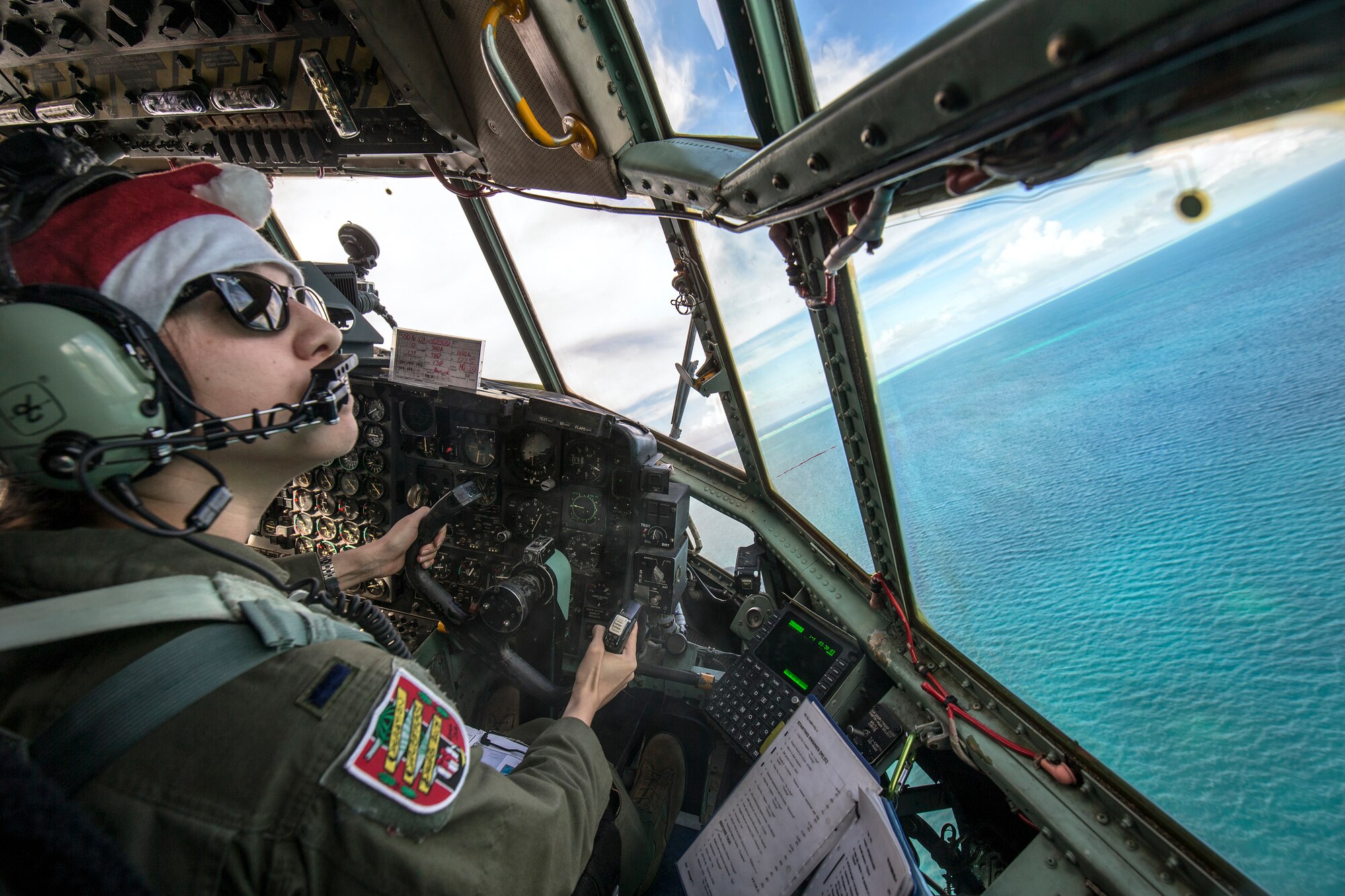 1st Lt. Sydney Croxton, 36th Airlift Squadron C-130 pilot, flies over Republic of Palau, Dec. 11, 2015, during Operation Christmas Drop. This year marks the 64th year of Operation Christmas Drop, which began in 1952, and is the first trilateral execution of the event with support from Japan Air Self-Defense Force and Royal Australian Air Force C-130s. (U.S. Air Force photo by Osakabe Yasuo/Released)
 
