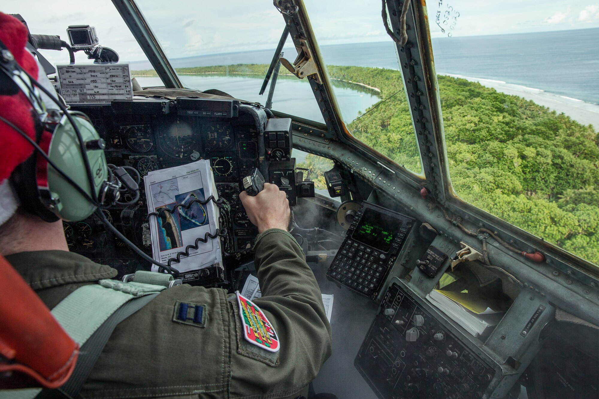 A pilot with the 36th Airlift Squadron fly over Ettal Atoll, Federated States of Micronesia, Dec. 9, 2015, during Operation Christmas Drop. Every December, C-130H Hercules aircrews from Yokota head to Andersen Air Force Base to execute low-cost, low-altitude humanitarian airdrops to islanders throughout the Commonwealth of the Northern Marianas, Federated States of Micronesia, Republic of Palau. These islands are some of the most remote locations on the globe spanning a distance nearly as broad as the continental U.S. It is the longest-running Department of Defense humanitarian airdrop operation with 2015 being the first trilateral execution with support from Japan Air Self-Defense Force and Royal Australian Air Force. (U.S. Air Force photo by Osakabe Yasuo/Released) 
