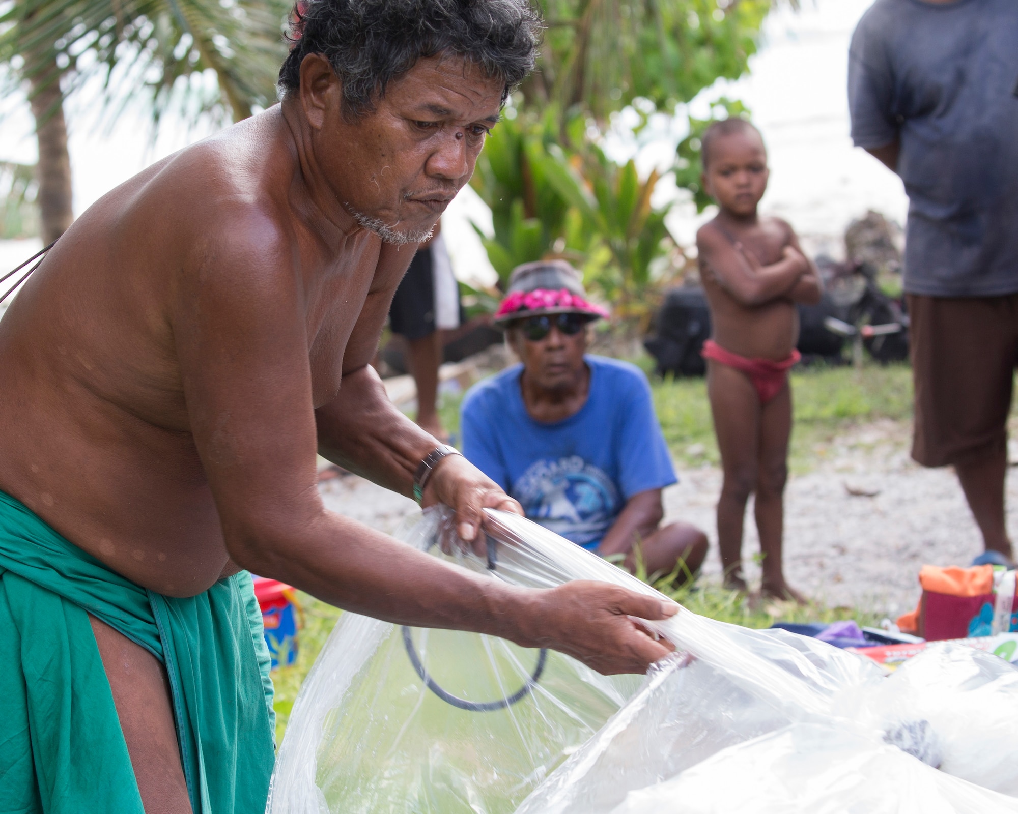 Louis Mangtau, Chief of Fais Island, sorts through supplies that were dropped during Operation Christmas Drop 2015, Dec. 8, 2015, at Fais Island, Federated States of Micronesia. Operation Christmas Drop is a humanitarian/disaster relief training event where C-130 crews provide critical supplies to 56 islands throughout the Commonwealth of the Northern Marianas, Federated States of Micronesia and Republic of Palau. This year marks the first ever trilateral execution that includes air support from the U.S. Air Force, Japan Air Self-Defense Force and the Royal Australian Air Force. (U.S. Air Force photo by Osakabe Yasuo/Released)
 
