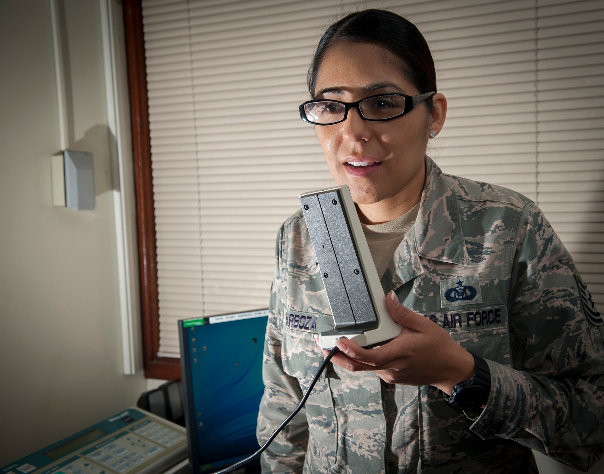 U.S. Air Force Tech. Sgt. Michelle Barboza, 18th Wing Command Post NCO in charge of training, makes a base-wide announcement using the giant voice system Jan. 11, 2016, at Kadena Air Base, Japan. The giant voice system is one method available to Command Post controllers to disseminate information to Team Kadena. (U.S. Air Force photo by Master Sgt. Jason W. Edwards)