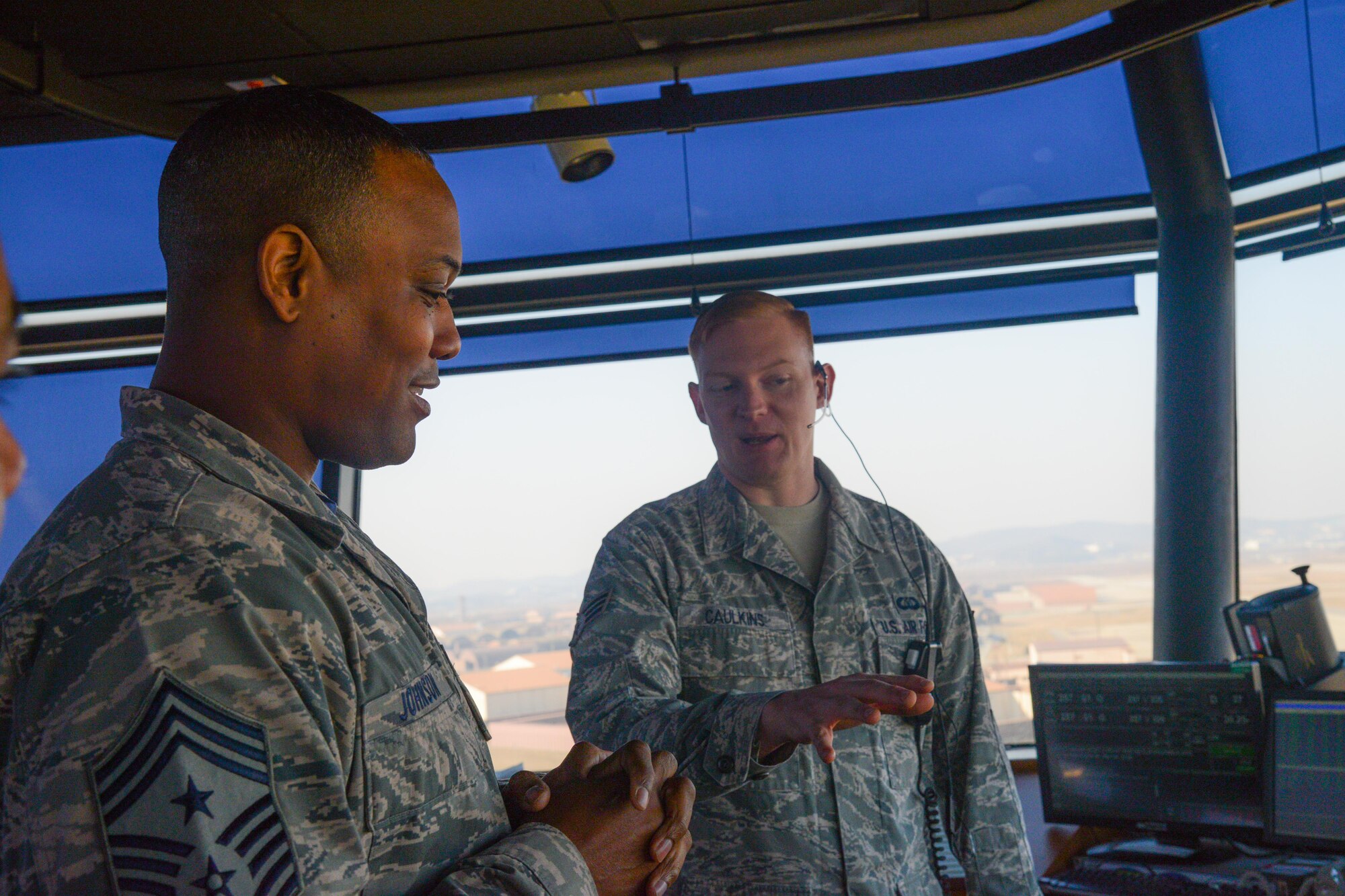 Seventh Air Force Command Chief Master Sgt. Anthony Johnson speaks with Senior Airman Brandan Caulkins, 51st Operation Support Squadron air traffic controller journeyman, during the chief’s 51st Operations Group immersion at Osan Air Base, Republic of Korea, Jan. 8, 2016. Johnson visited Osan’s air traffic control tower to better understand the challenges the ATC career field possesses like enlisted manning and training constraints. (U.S. Air Force photo/Airman 1st Class Dillian Bamman)