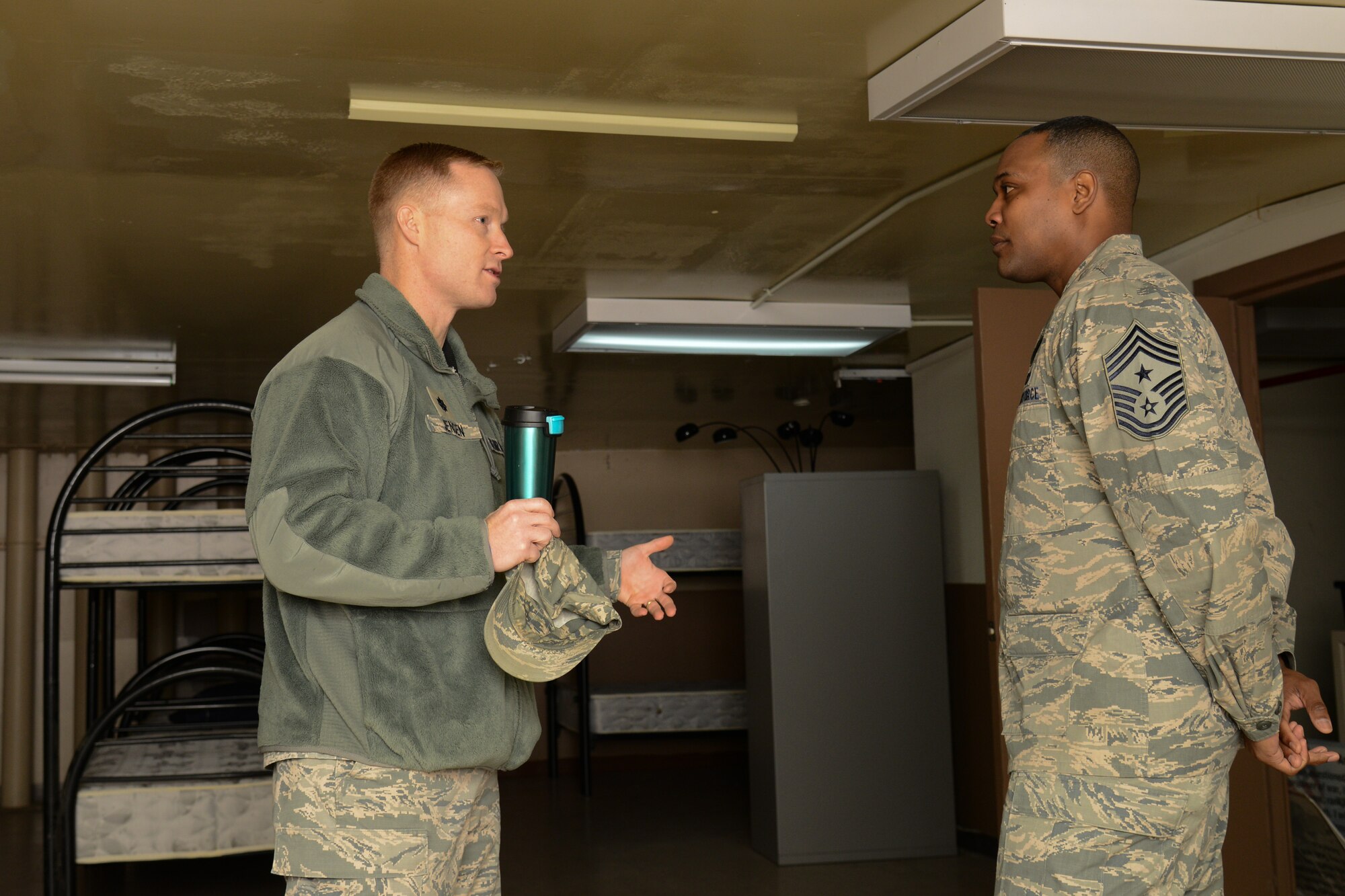 Lt. Col. Jason Jensen, 51st Operation Support Squadron commander, speaks with Seventh Air Force Command Chief Master Sgt. Anthony Johnson inside the squadron’s bed down area during the chief’s 51st Operations Group immersion at Osan Air Base, Republic of Korea, Jan. 8, 2016. Johnson toured the group to engage with Team Osan Airmen and observe their mission capabilities and limitations. (U.S. Air Force photo/Airman 1st Class Dillian Bamman)