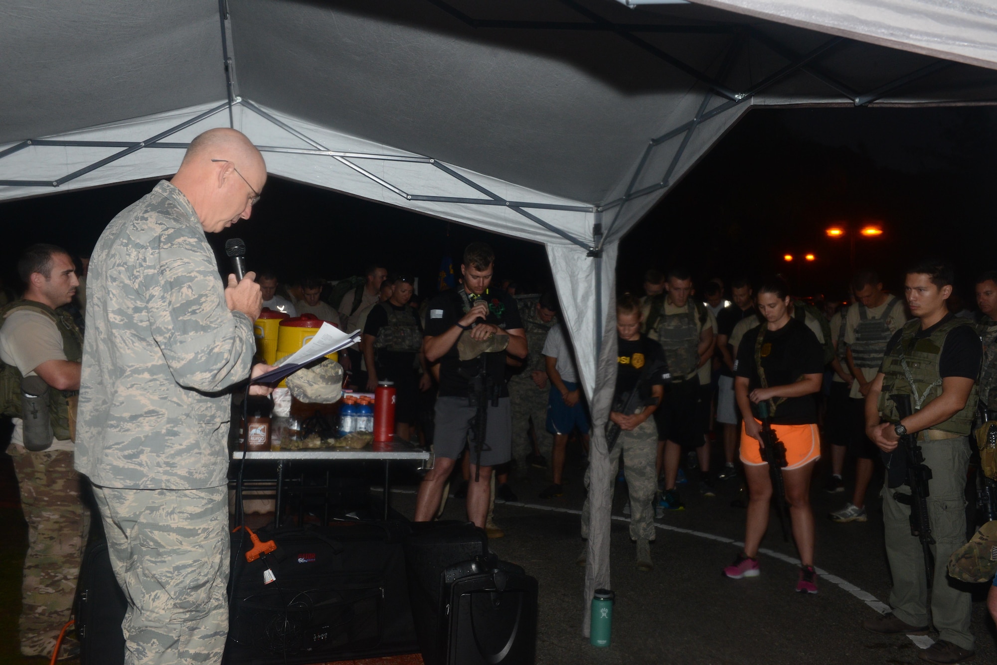 Lt. Col. Glenn Gresham, 36th Wing chaplain, leads service members in a prayer before a memorial 6K Jan. 8, 2016, at Andersen Air Force Base, Guam. Air Force Office of Special Investigations Det. 602, 36th Security Forces Squadron and 736th SFS hosted a 6K memorial run to honor the four AFOSI special agents and two security forces members who were killed by a motorcycle-borne improvised explosive device on Dec. 21, 2015, outside of Bagram Air Base, Afghanistan. (U.S. Air Force photo/Airman 1st Class Arielle Vasquez)