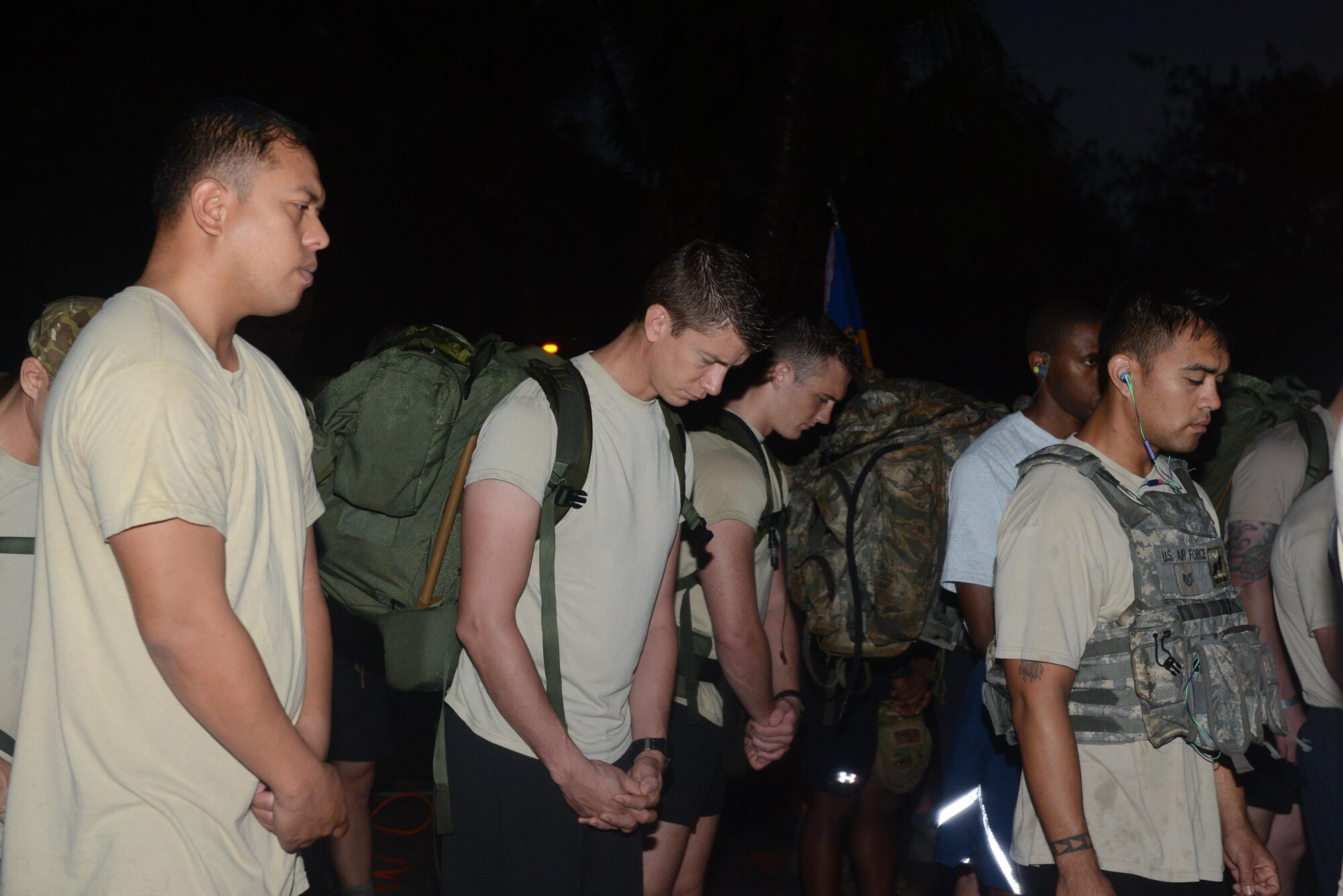 Service members pause for a moment of silence before a memorial 6K Jan. 8, 2016, at Andersen Air Force Base, Guam. Air Force Office of Special Investigations Det. 602, 36th Security Forces Squadron and 736th SFS hosted a 6K memorial run to honor the four AFOSI special agents and two security forces members who were killed by a motorcycle-borne improvised explosive device on Dec. 21, 2015, outside of Bagram Air Base, Afghanistan. (U.S. Air Force photo/Airman 1st Class Arielle Vasquez)