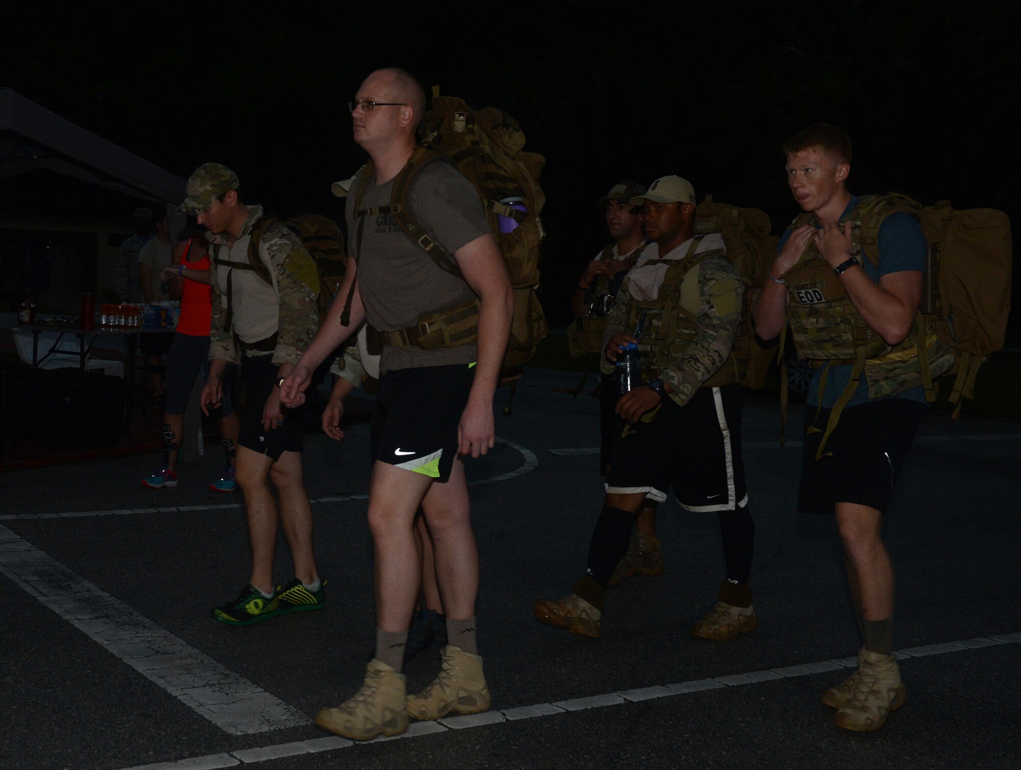 Service members conduct a ruck march during the 6K memorial run Jan. 8, 2016, at Andersen Air Force Base, Guam. Service members ran six kilometers to represent the six Airmen who were killed while conducting counter-threat operations outside of Bagram Air Base, Afghanistan. (U.S. Air Force photo/Airman 1st Class Arielle Vasquez)