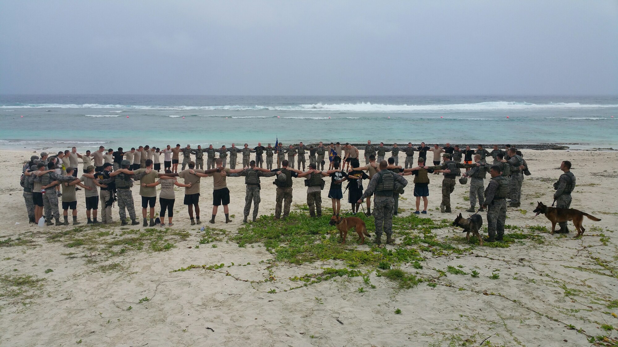 Service members join in a circle in memory of the six Airmen who were killed in late December while conducting counter-threat operations outside of Bagram Air Base, Afghanistan, Jan. 8, 2016, at Andersen Air Force Base, Guam. In honor of the four Air Force Office of Special Investigations special agents and two security forces members who were killed in Afghanistan, a 6K memorial run was held, with every kilometer representing one of the Airmen who was killed. (Courtesy photo)