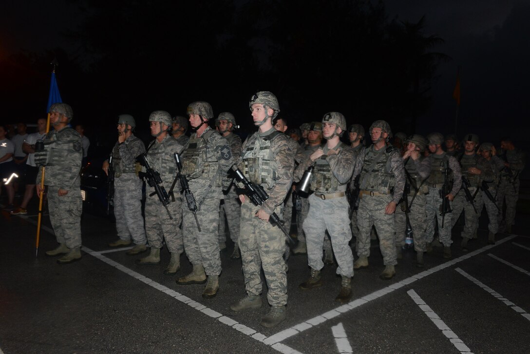 Security Forces members stand in formation before a memorial 6K Jan. 8, 2016, at Andersen Air Force Base, Guam. Air Force Office of Special Investigations Det. 602, 36th Security Forces Squadron and 736th SFS hosted a 6K memorial run to honor the four AFOSI special agents and two security forces members who were killed by a motorcycle-borne improvised explosive device on Dec. 21, 2015, outside of Bagram Air Base, Afghanistan. (U.S. Air Force photo/Airman 1st Class Arielle Vasquez)