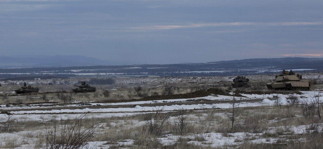 U.S. Marine M1A1 Abrams tanks and Bulgarian T-72 tanks conduct maneuver training during Platinum Lion 16-2 at Novo Selo Training Area, Bulgaria, Jan. 8, 2016. Exercise Platinum Lion provides combined training with NATO Allies and partners, demonstrating our commitment to promoting a peaceful and stable Europe through theatre security cooperation engagements. (U.S. Marine Corps Photo by Cpl. Justin T. Updegraff/ Released)