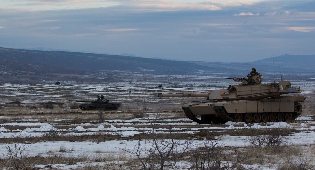 U.S. Marine M1A1 Abrams tanks and Bulgarian T-72 tanks conduct maneuver training during Platinum Lion 16-2 at Novo Selo Training Area, Bulgaria, Jan. 8, 2016. Exercise Platinum Lion provides combined training with NATO Allies and partners, demonstrating our commitment to promoting a peaceful and stable Europe through theatre security cooperation engagements. (U.S. Marine Corps Photo by Cpl. Justin T. Updegraff/ Released)