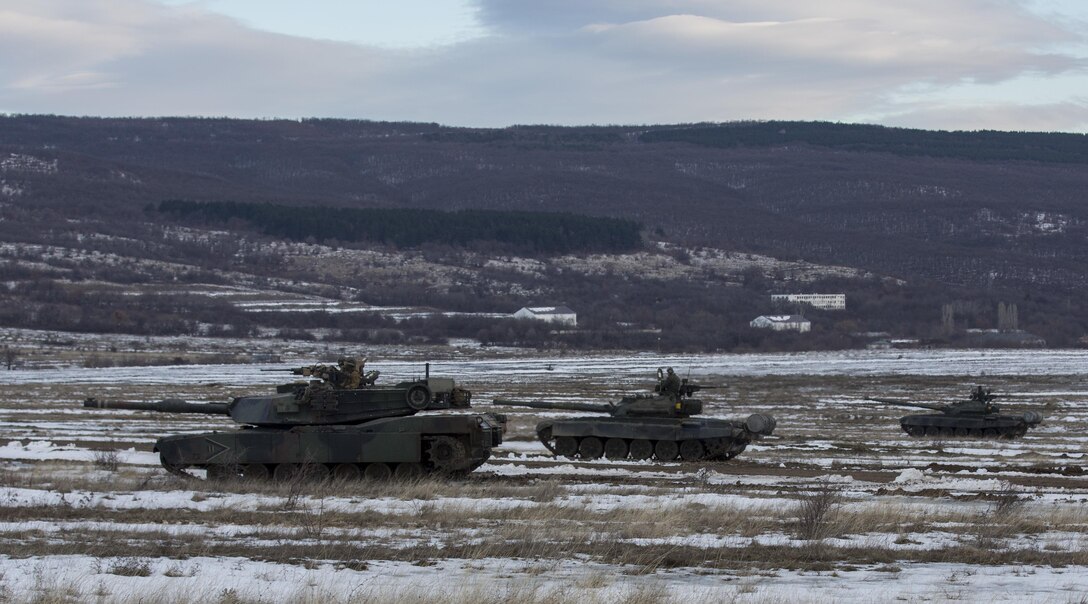 U.S. Marine M1A1 Abrams tanks and Bulgarian T-72 tanks conduct maneuver training during Platinum Lion 16-2 at Novo Selo Training Area, Bulgaria, Jan. 8, 2016. Exercise Platinum Lion provides combined training with NATO Allies and partners, demonstrating our commitment to promoting a peaceful and stable Europe through theatre security cooperation engagements. (U.S. Marine Corps Photo by Cpl. Justin T. Updegraff/ Released)