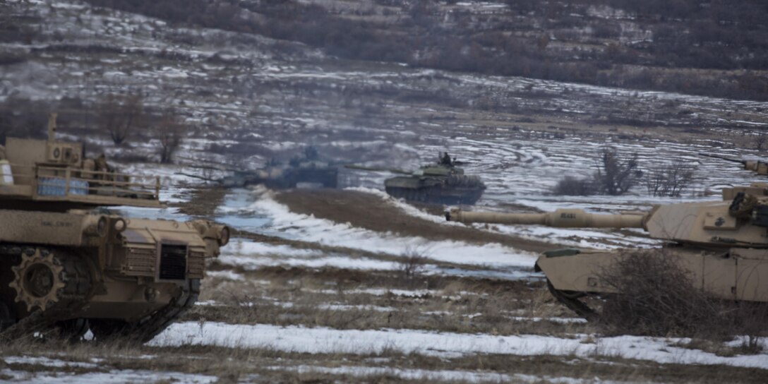 U.S. Marine M1A1 Abrams tanks and Bulgarian T-72 tanks conduct maneuver training during Platinum Lion 16-2 at Novo Selo Training Area, Bulgaria, Jan. 8, 2016. Exercise Platinum Lion provides combined training with NATO Allies and partners, demonstrating our commitment to promoting a peaceful and stable Europe through theatre security cooperation engagements. (U.S. Marine Corps Photo by Cpl. Justin T. Updegraff/ Released)