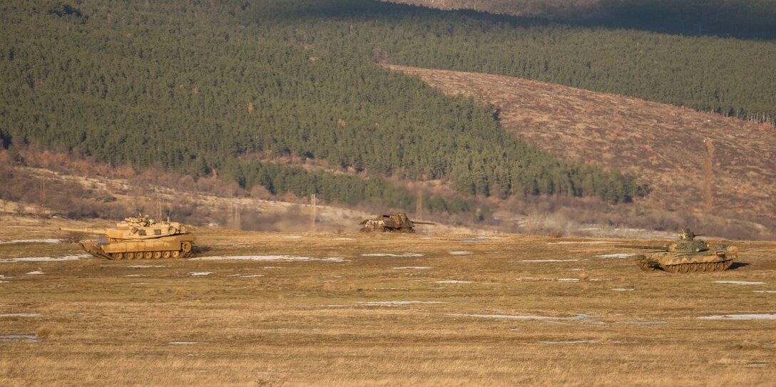 U.S. Marine M1A1 Abrams tanks and Bulgarian T-72 tanks conduct maneuver training during Platinum Lion 16-2 at Novo Selo Training Area, Bulgaria, Jan. 8, 2016. Exercise Platinum Lion provides combined training with NATO Allies and partners, demonstrating our commitment to promoting a peaceful and stable Europe through theatre security cooperation engagements. (U.S. Marine Corps Photo by Cpl. Justin T. Updegraff/ Released)