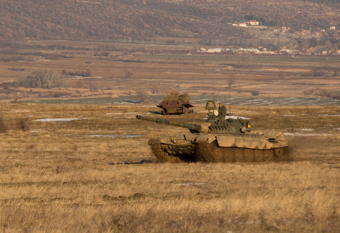 U.S. Marine M1A1 Abrams tanks and Bulgarian T-72 tanks conduct maneuver training during Platinum Lion 16-2 at Novo Selo Training Area, Bulgaria, Jan. 8, 2016. Exercise Platinum Lion provides combined training with NATO Allies and partners, demonstrating our commitment to promoting a peaceful and stable Europe through theatre security cooperation engagements. (U.S. Marine Corps Photo by Cpl. Justin T. Updegraff/ Released)