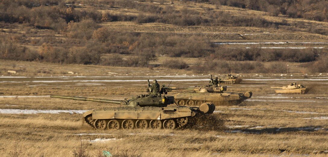 U.S. Marine M1A1 Abrams tanks and Bulgarian T-72 tanks conduct maneuver training during Platinum Lion 16-2 at Novo Selo Training Area, Bulgaria, Jan. 8, 2016. Exercise Platinum Lion provides combined training with NATO Allies and partners, demonstrating our commitment to promoting a peaceful and stable Europe through theatre security cooperation engagements. (U.S. Marine Corps Photo by Cpl. Justin T. Updegraff/ Released)