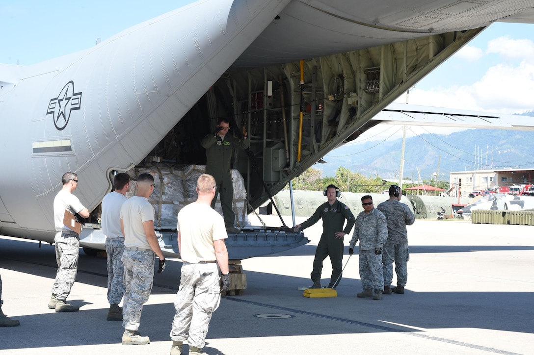U.S. Air Force airmen unload cargo from a U.S. Air Force C-130J Super Hercules cargo aircraft on Soto Cano Air Base, Honduras, Jan. 7, 2016. The airmen are assigned to the 612th Air Base Squadron. The 612th routinely facilitates cargo delivery through the Denton Program, which allows nonprofit organizations to ship humanitarian aid to remote areas the aircraft are scheduled to visit. U.S. Air Force photo by Martin Chahin