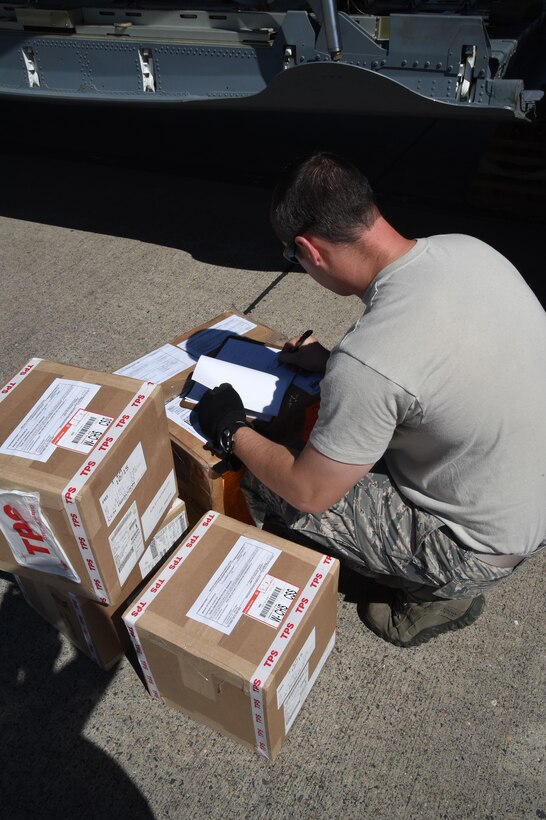 U.S. Air Force Tech. Sgt. Deavin Lee checks cargo on Soto Cano Air Base, Honduras, Jan. 7, 2016. Lee is assigned to the 612th Air Base Squadron. The cargo was donated by Helping Hands Ministries and Operations Ukraine and will help Honduran families. U.S. Air Force photo by Martin Chahin