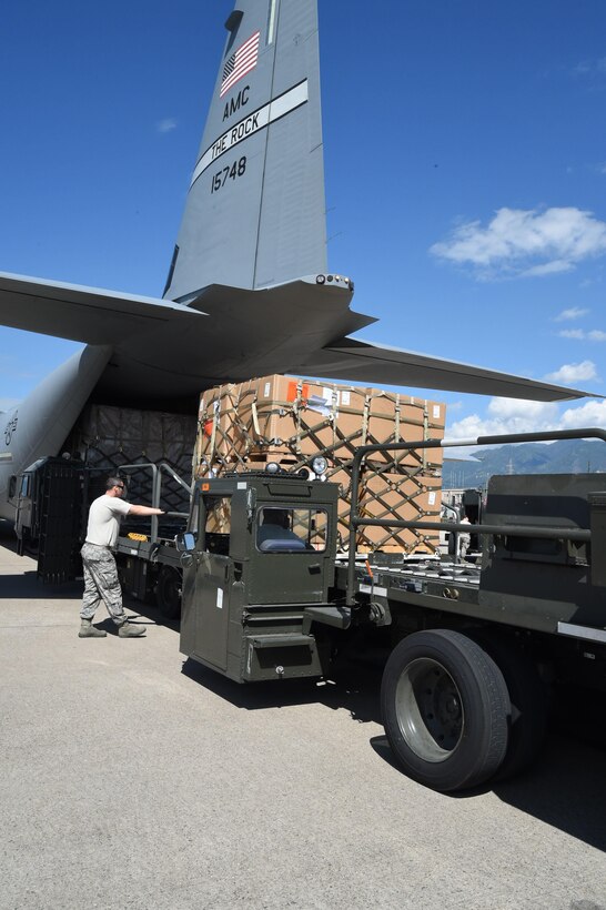 U.S. Air Force Tech. Sgt. Deavin Lee unloads cargo from a U.S. Air Force C-130J Super Hercules cargo aircraft on Soto Cano Air Base, Honduras, Jan. 7, 2016. Lee is assigned to the 612th Air Base Squadron. U.S. Air Force photo by Martin Chahin