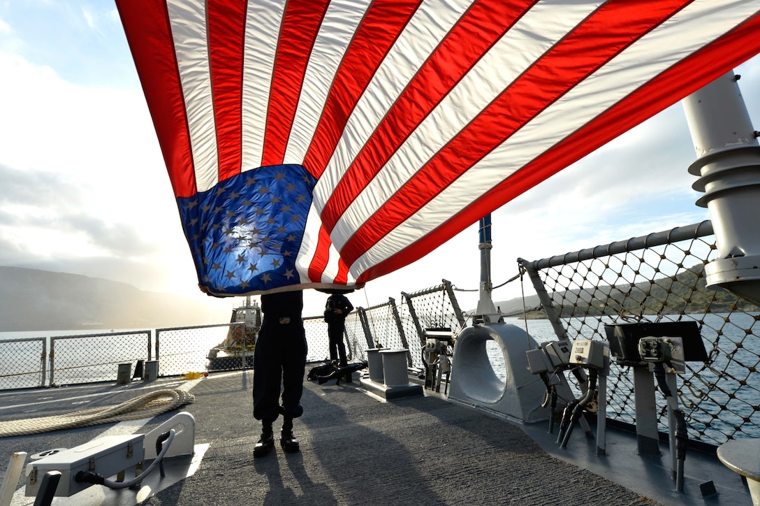 U.S. sailors aboard the USS Ross prepare to shift colors during sea and anchor detail before pulling into Souda Bay, Greece, Jan. 9, 2016. The Ross is an Arleigh Burke-class guided missile destroyer deployed to Rota, Spain. U.S. Navy photo by Petty Officer 2nd Class Justin Stumberg